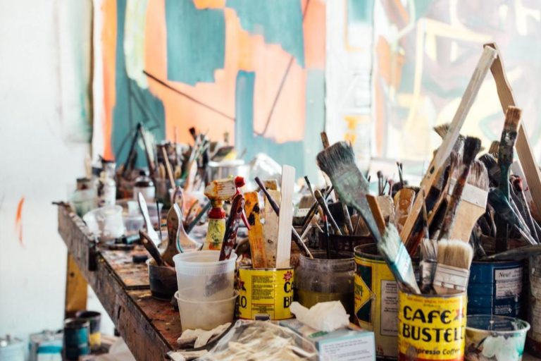 Artist brushes and paints in an art studio