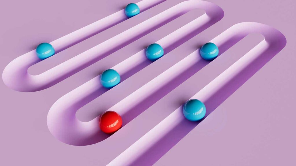 red and blue contrasting balls in a groove curving across the pink background