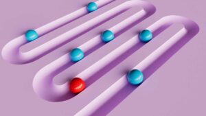 red and blue contrasting balls in a groove curving across the pink background