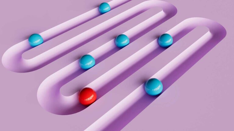 red and blue contrasting balls in a groove curving across the pink background